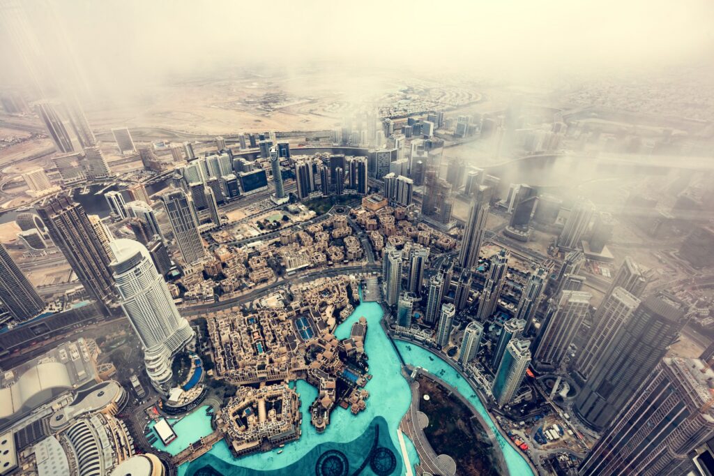 Dubai UAE aerial rooftop view from Burj Khalifa in clouds.